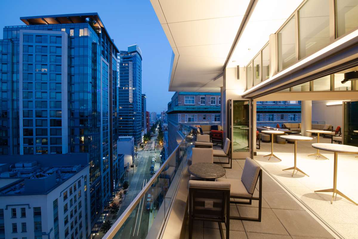 A balcony with a city view and outdoor furniture